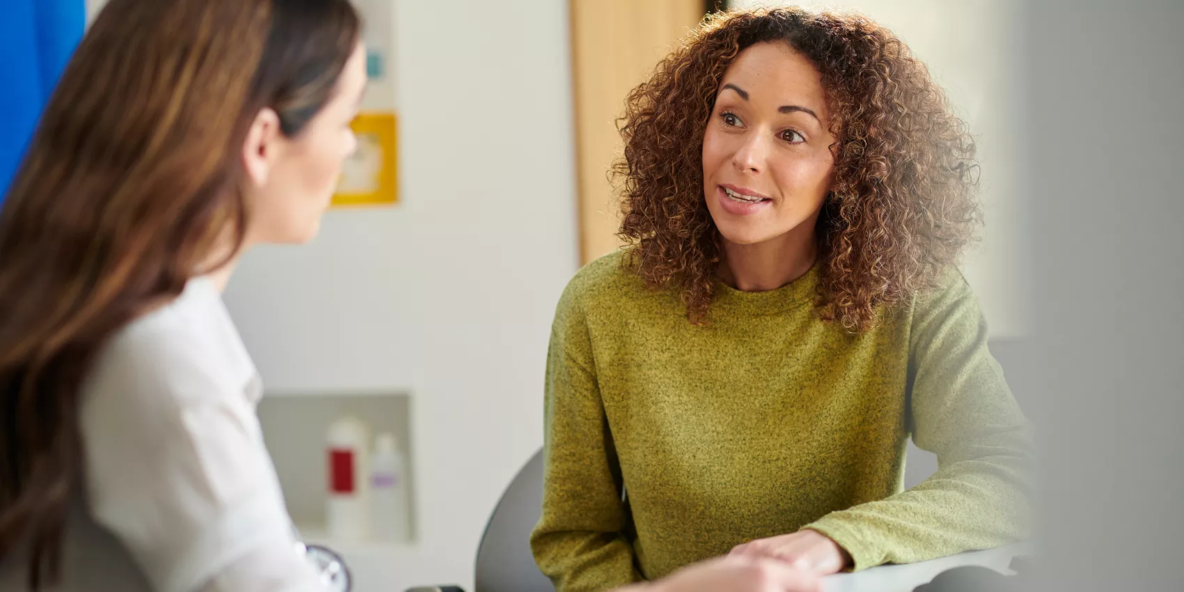 A GP talking with her patient during a consultation