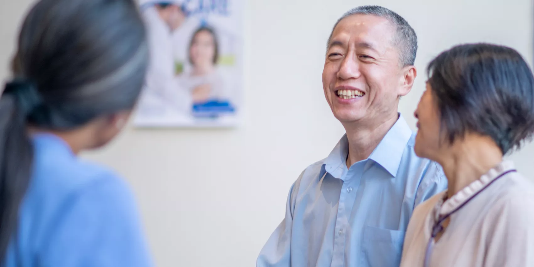 Older Australian couple speaking with their healthcare professional