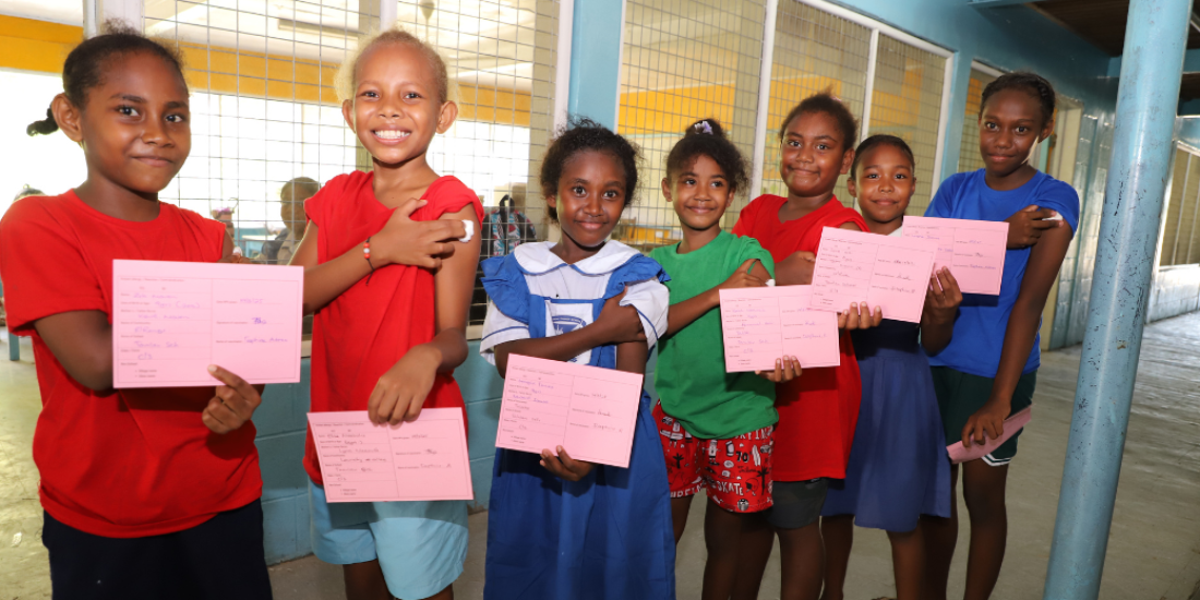 Children line up after being vaccinated in the Pacific