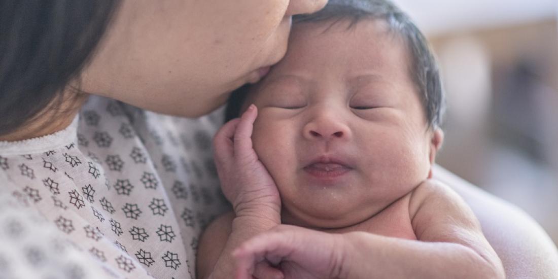 A mother holding a newborn baby