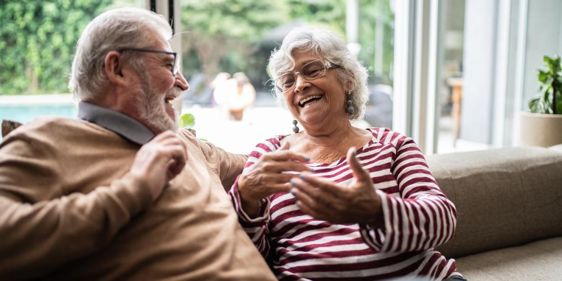 An image of two older Australians sitting and laughing