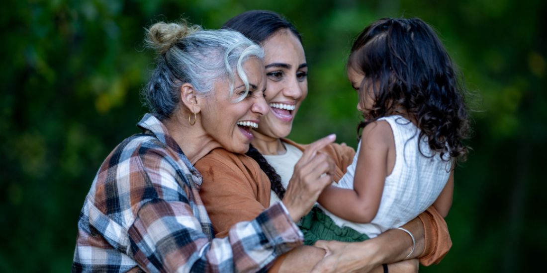 Grandmother, mother and young child enjoying time together outdoors